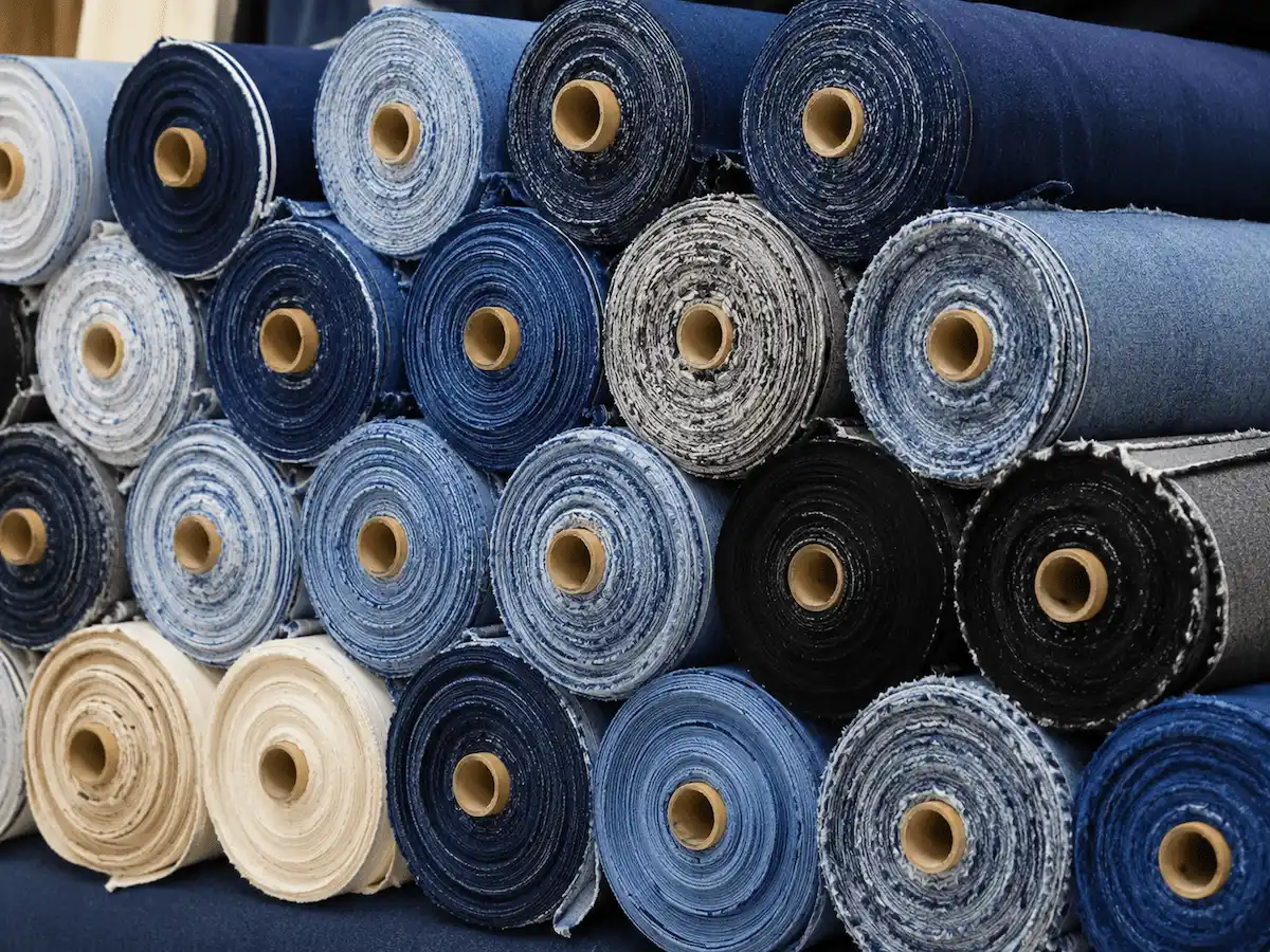 Different types of denim fabric swatches including selvedge stretch organic and heavyweight options for custom jeans and jackets manufacturing