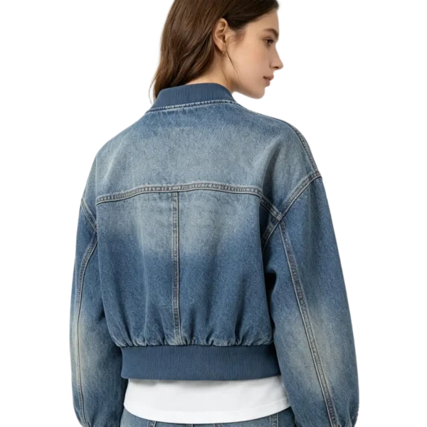 Cropped women's denim bomber jacket rib-knit texture denim fabric and zip macro close-up