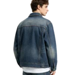 Heavyweight men's denim chore coat reinforced stitch detail fabric weight and pocket construction macro close-up