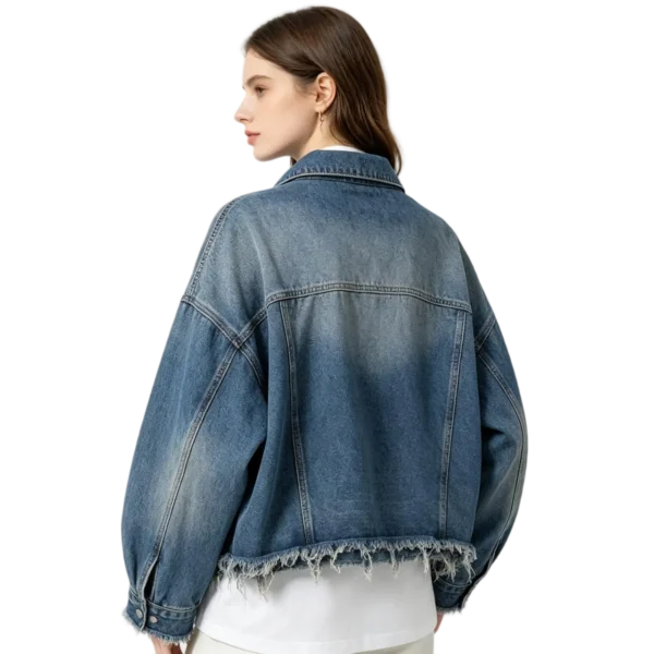 Oversized women's frayed hem denim jacket raw edge detail washed fabric and seam macro close-up