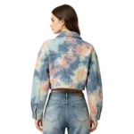 Tie-dye cropped women's denim jacket color blend effect washed fabric and dye pattern macro close-up