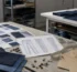 Denim manufacturing for independent designers — design sketches, fabric swatches and hardware on a studio workbench